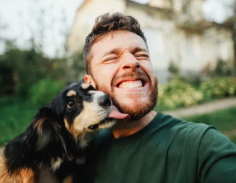 Dog licking a man's face